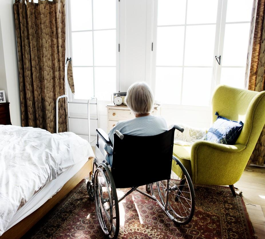 Woman in wheelchair in nursing home room