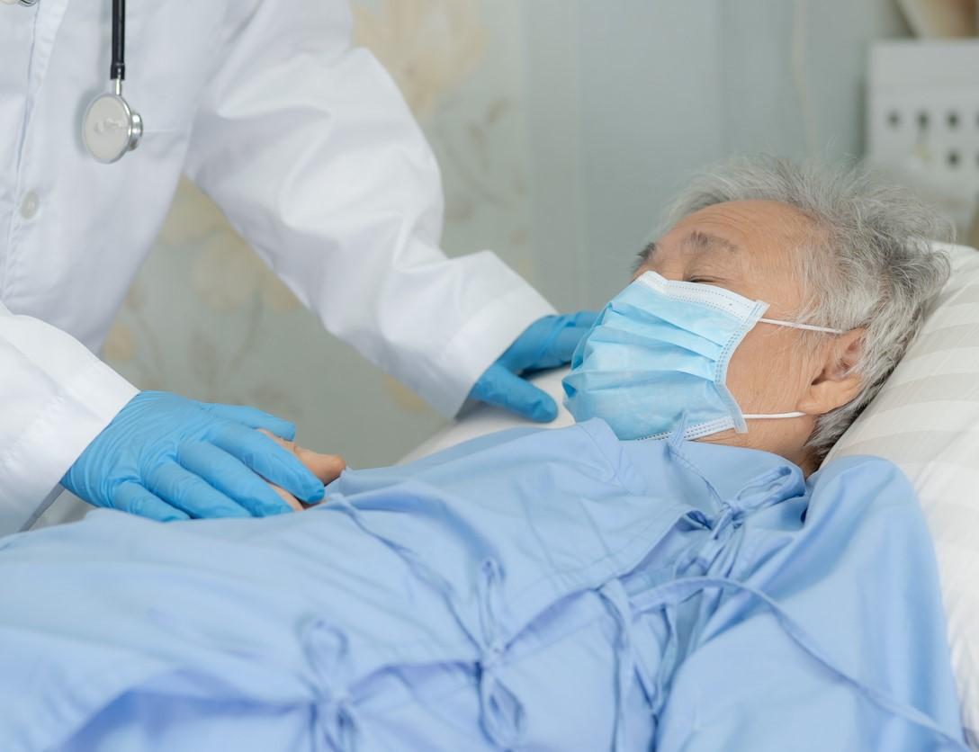 Elderly hospital patient wearing mask