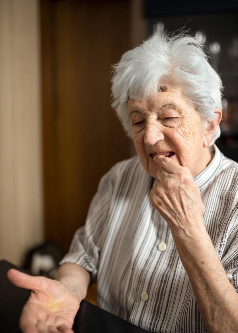 Older woman taking pill