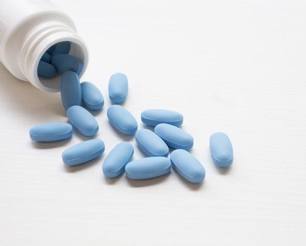 Oval blue pills and bottle