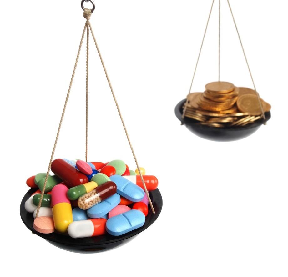 Pills and coins on a scale
