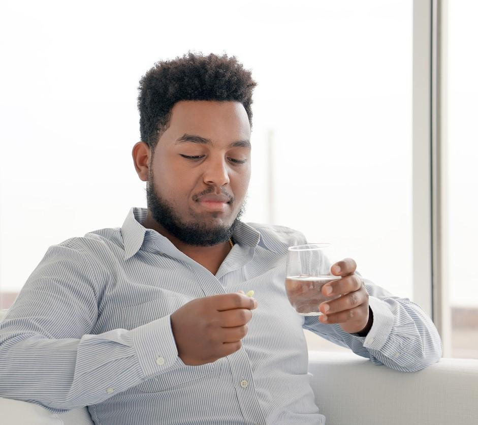 Man taking an antiviral