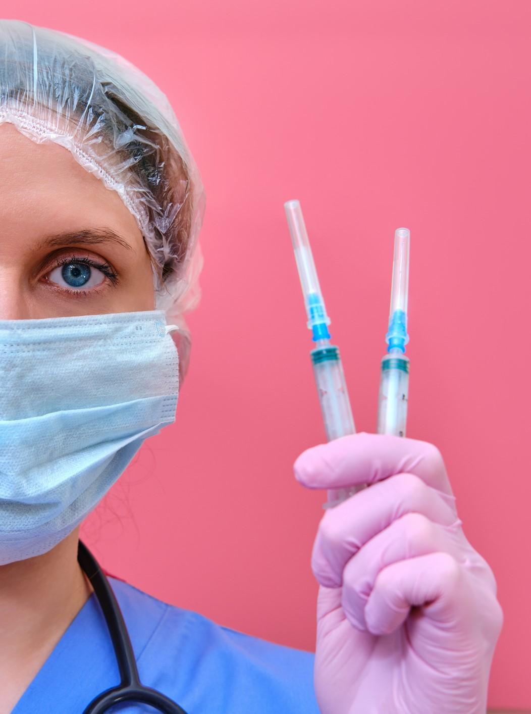 doctor holding vaccines