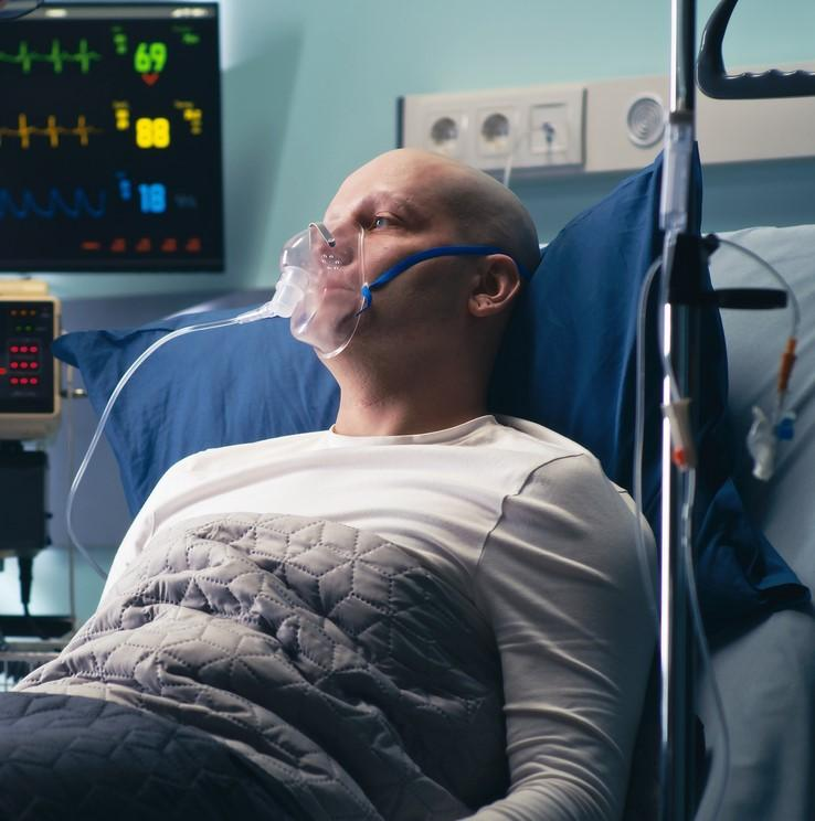 Immunocompromised man in hospital bed