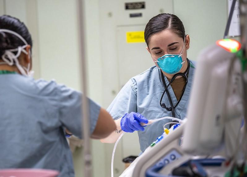 Nurses attending a flu patient in the hospital