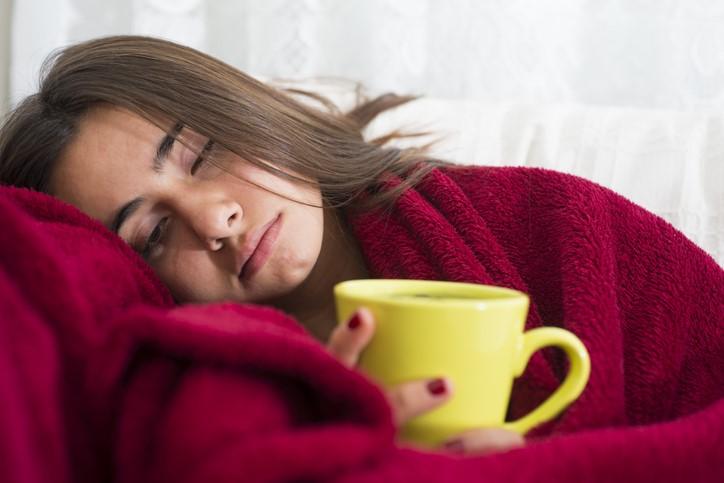 sick woman with hot tea