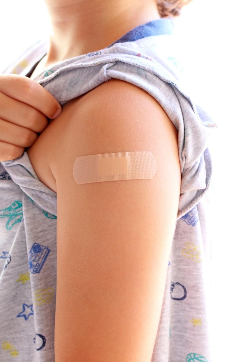 Vaccinated child with bandage on arm