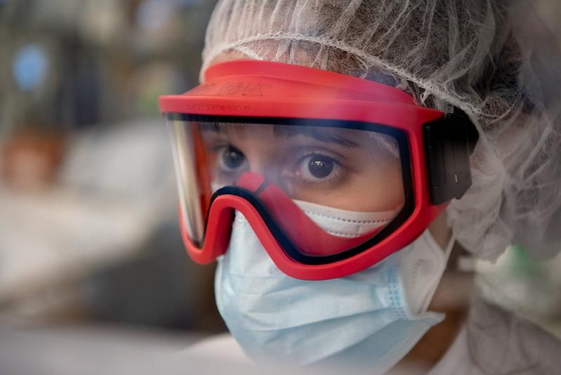 Healthcare worker wearing a medical mask on top of a respirator