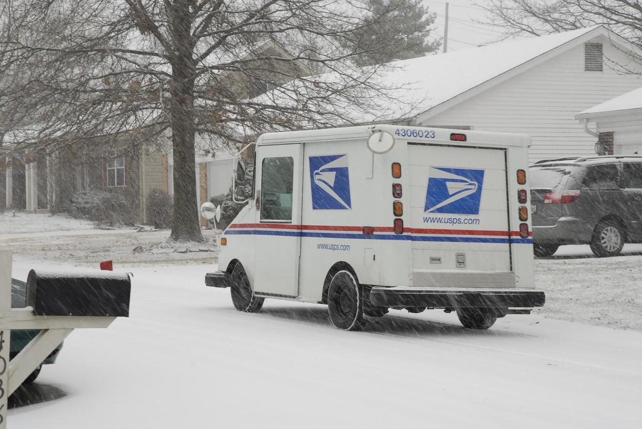 mail truck in snowstorm