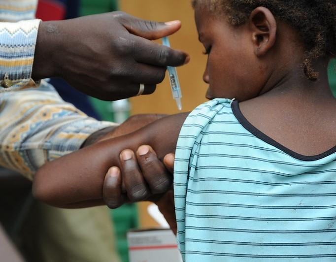 Child gets vaccine in Africa