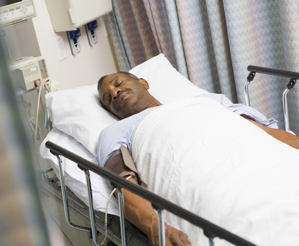 Sleeping black man in hospital bed