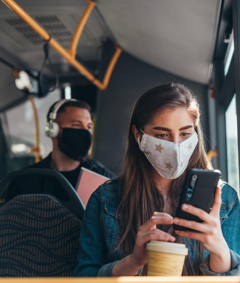 Woman wearing mask on bus