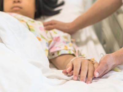 Caring for girl in hospital bed