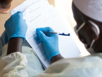 Ebola nurse documenting in patient chart