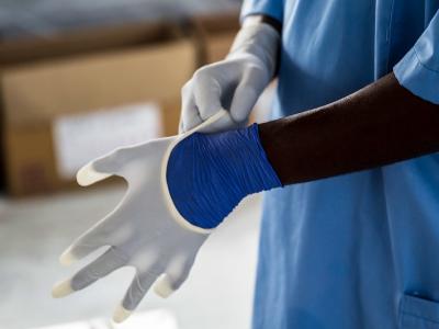 Ebola worker putting gloves on