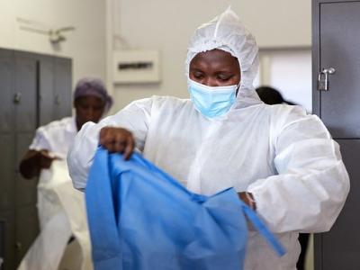 Healthcare workers in South Africa putting on protective equipment