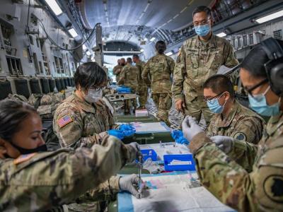 National Guard troops aboard airplane with COVID vaccine