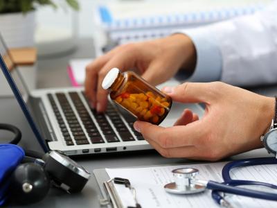 Prescribing antibiotics with laptop