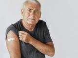Older man with vaccine band-aid