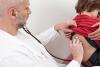 Doctor using stethoscope on boy